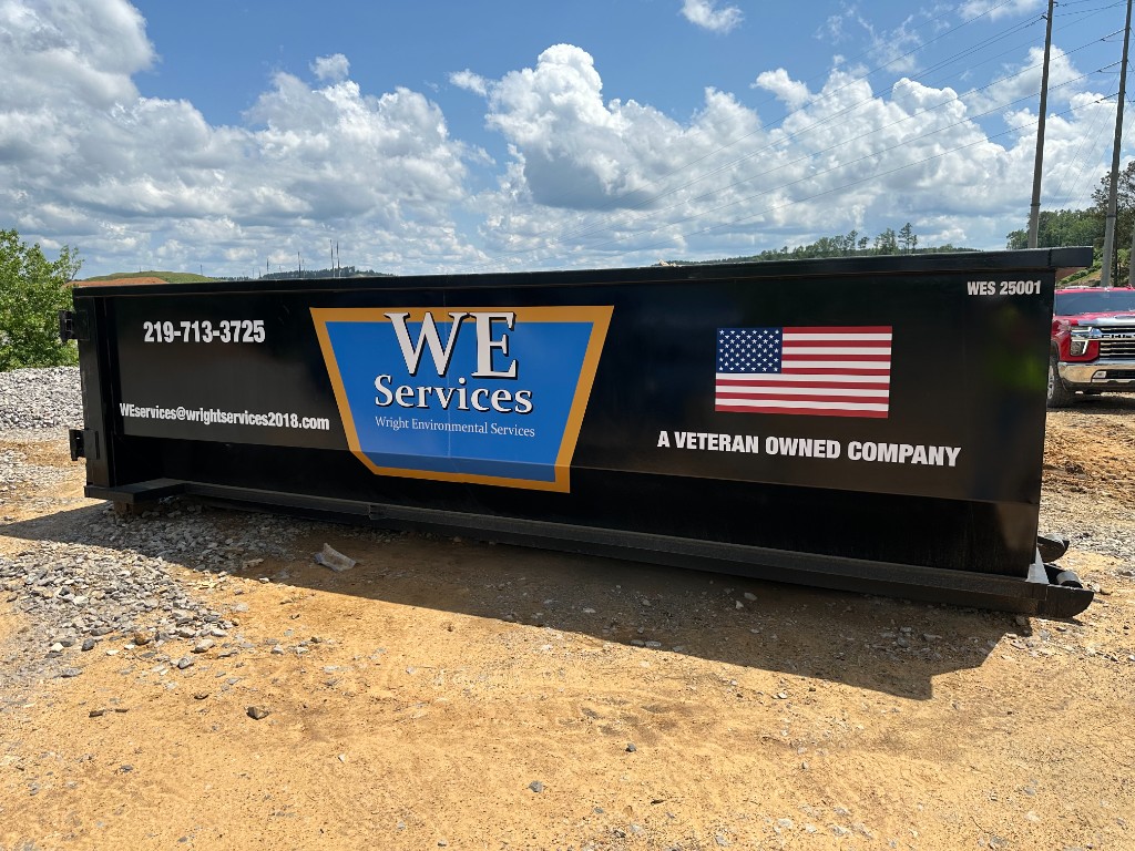 WE Services roll-off container side view showing company branding and Veteran Owned Company designation